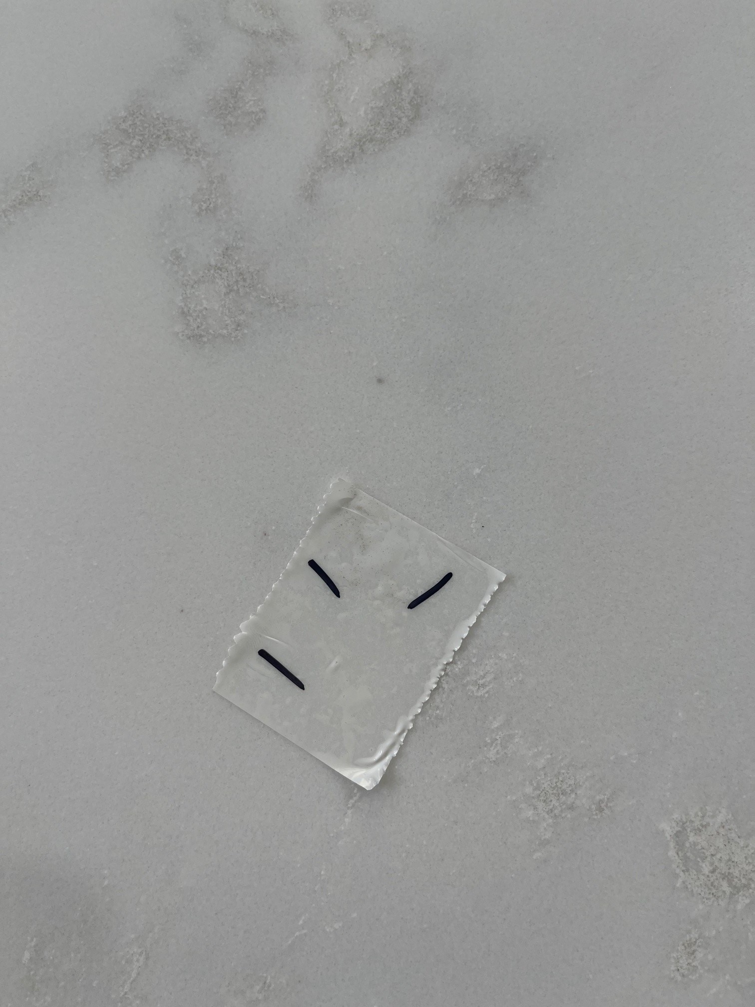 CRL Luna Bianco Dots quartz worktops close up A premium quartz slab marked to show unexpected spots.