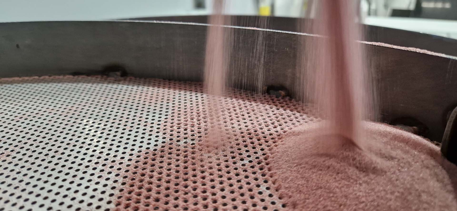Garnet sand poured into the feed hopper of the Intermac Waterjet